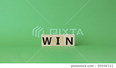 Win symbol. Wooden blocks with words Win. Beautiful green background. Business and Win concept. Copy space. 95036131