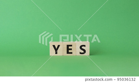 Yes symbol. Wooden blocks with word yes. Beautiful green background. Business and yes concept. Copy space. Yes symbol. Wooden blocks with word yes. Beautiful green background. Business and yes concept. Copy space. 95036132