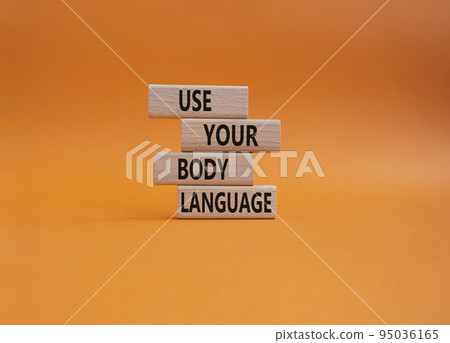 Use your Body Language symbol. Concept words Use your Body Language on wooden blocks. Beautiful orange background. Business and Use your Body Language concept. Copy space 95036165