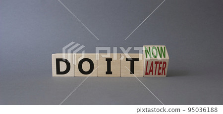 Do it now or later symbol. Turned wooden cubes with words SDo it now or later. Beautiful grey background. Business concept. Copy space Do it now or later symbol. Turned wooden cubes with words SDo it now or later. Beautiful grey background. Business concept. Copy space 95036188