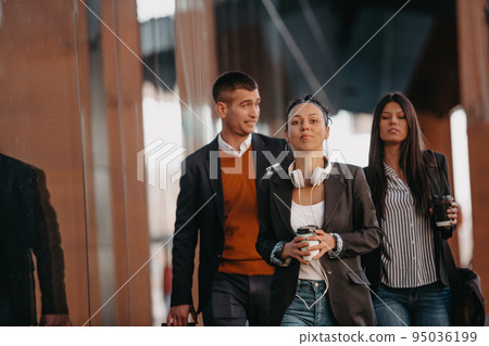 Elegant businesspeople walking in a modern city.. 95036199