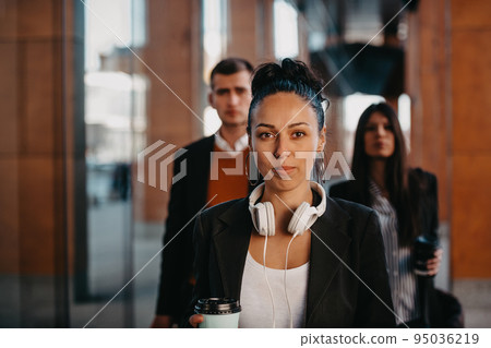 Elegant businesspeople walking in a modern city.. Elegant businesspeople walking in a modern city.. 95036219