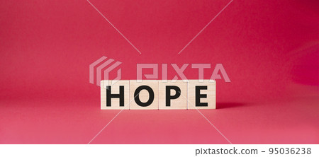 Hope symbol. Concept word Hope on wooden cubes. Beautiful red background. Business and Hope concept. Copy space. Hope symbol. Concept word Hope on wooden cubes. Beautiful red background. Business and Hope concept. Copy space. 95036238