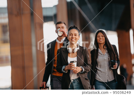 Elegant businesspeople walking in a modern city.. 95036249