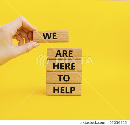 We are here to help symbol. Concept words we are here to help on wooden blocks. Beautiful yellow background. Business and we are here to help concept. Copy space. 95036323