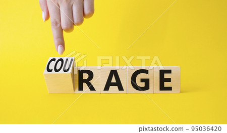 Courage and rage symbol. Businessman hand points at wooden cubes with words Rage and Courage. Beautiful yellow background. Business concept. Copy space. Courage and rage symbol. Businessman hand points at wooden cubes with words Rage and Courage. Beautiful yellow background. Business concept. Copy space. 95036420