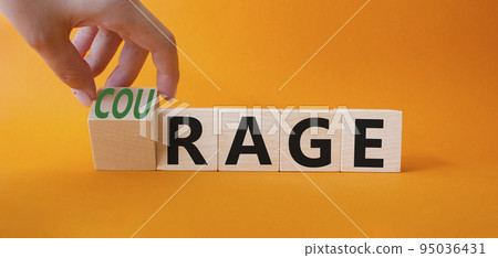 Courage and rage symbol. Businessman hand turnes wooden cubes and changes word Rage to Courage. Beautiful orange background. Business concept. Copy space. 95036431