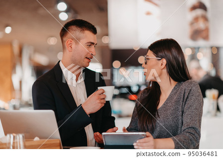 Modern man and woman use modern devices, laptop, tablet and smartphone and arrange new projects for the job. Business concept . 95036481