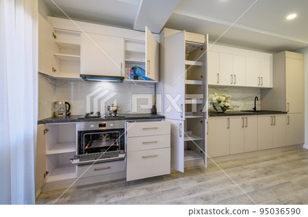 Luxury beige and cream kitchen interior details, some drawers retracted Luxury beige and cream kitchen interior details, some drawers retracted 95036590