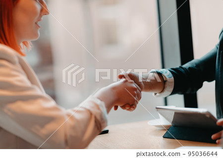 Business women shake hands while arranging a business 95036644