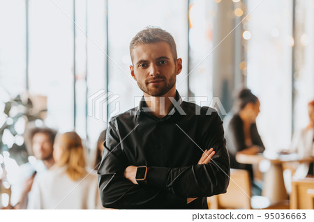 Cheerful self confident professional businessman with crossed hands portrait. 95036663