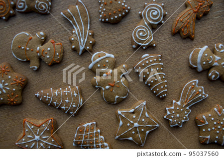 Set of different homemade Christmas cookies isolated on background, close up view with copy space for text. New year frame with tasty gingerbread cookies with spices. Winter holiday concept Set of different homemade Christmas cookies isolated on background, close up view with copy space for text. New year frame with tasty gingerbread cookies with spices. Winter holiday concept 95037560