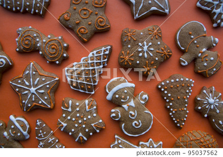 Set of different homemade Christmas cookies isolated on background, close up view with copy space for text. New year frame with tasty gingerbread cookies with spices. Winter holiday concept 95037562
