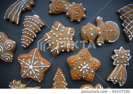 Set of different homemade Christmas cookies isolated on background, close up view with copy space for text. New year frame with tasty gingerbread cookies with spices. Winter holiday concept Set of different homemade Christmas cookies isolated on background, close up view with copy space for text. New year frame with tasty gingerbread cookies with spices. Winter holiday concept 95037580