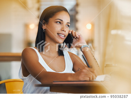 Freelance worker working in a coffee shop talking on a phone call about a growth strategy. Young female student with a positive mindset doing remote work in a cafe and having a mobile conversation 95038287