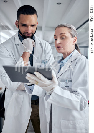Tablet, science and research with a man and woman scientist working on the internet in their laboratory. Innovation, technology and analytics with a medicine team at work in collaboration in the lab 95038333