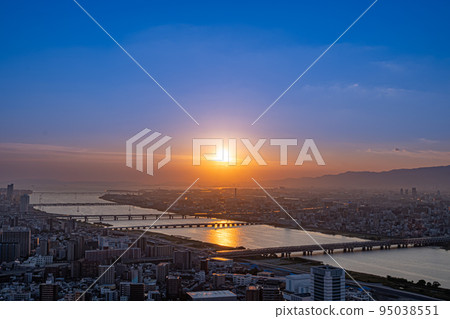 Osaka cityscape and Yodo River illuminated by the setting sun [Osaka scenery] 95038551