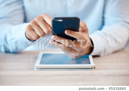 Internet, technology and communication, a man with phone in hand and tablet on desk. Businessman online in contact with client, reading email or browsing social media. Fintech, ux and payment via app Internet, technology and communication, a man with phone in hand and tablet on desk. Businessman online in contact with client, reading email or browsing social media. Fintech, ux and payment via app 95038868