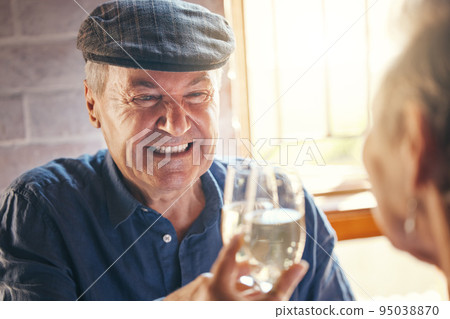 Champagne toast, celebration and senior couple with smile about retirement at restaurant. Elderly man and woman at dinner to celebrate anniversary, marriage and love with drink of wine and cheers Champagne toast, celebration and senior couple with smile about retirement at restaurant. Elderly man and woman at dinner to celebrate anniversary, marriage and love with drink of wine and cheers 95038870