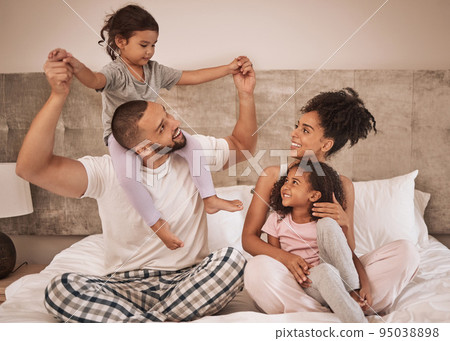 Family morning, bed relax and parents happy with children in bed, smile in bedroom of house and love for kids in home together. Girl siblings playing and bonding in happiness with mother and father Family morning, bed relax and parents happy with children in bed, smile in bedroom of house and love for kids in home together. Girl siblings playing and bonding in happiness with mother and father 95038898