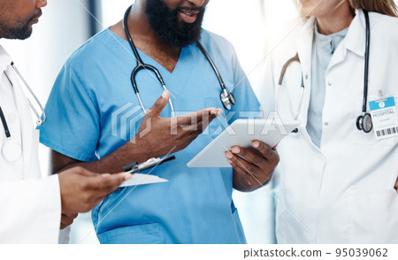 Tablet, healthcare and insurance with a doctor and his team doing research online for medical, trust and care. Collaboration, analytics and development with a health professional, surgeon and nurse 95039062