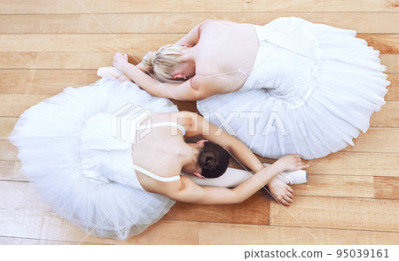 Ballet women, theatre concert and dance stage for creative training, performance and professional dancers. Above of two girl ballerinas stretching dancing and start music show action on studio floor 95039161
