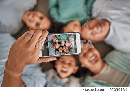Family selfie, phone face and hand of man with technology with grandparents and children, smile while relax and happy on living room floor. Parents, kids and elderly people taking photo on tech Family selfie, phone face and hand of man with technology with grandparents and children, smile while relax and happy on living room floor. Parents, kids and elderly people taking photo on tech 95039184