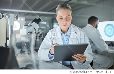 Science, tablet and innovation with a woman engineer doing research in a medical laboratory. Analytics, internet and technology with a doctor or scientist working on future development in her lab 95039194