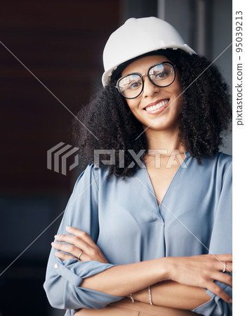 Engineer, technician and black woman with safety helmet, glasses and a smile while working in the construction, architect and engineering industry. Portrait of a happy female worker looking confident 95039213
