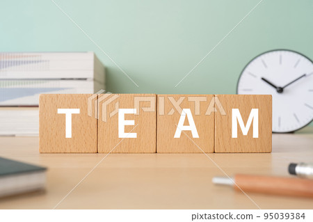 A desk with a block written as TEAM A desk with a block written as TEAM 95039384