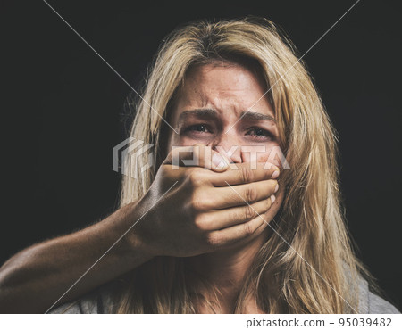 Woman, domestic violence and depression with hand on mouth for silence, gender abuse and sad in relationship. Model, distress and face cover by hand show inequality, anxiety and women fear Woman, domestic violence and depression with hand on mouth for silence, gender abuse and sad in relationship. Model, distress and face cover by hand show inequality, anxiety and women fear 95039482