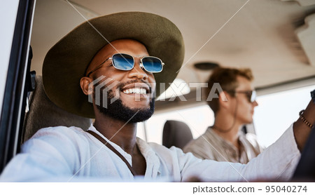 Happy, smile and black man driving a car while on a summer road trip vacation with friends. Happiness, freedom and young people having fun while traveling in a vehicle to holiday destination together Happy, smile and black man driving a car while on a summer road trip vacation with friends. Happiness, freedom and young people having fun while traveling in a vehicle to holiday destination together 95040274