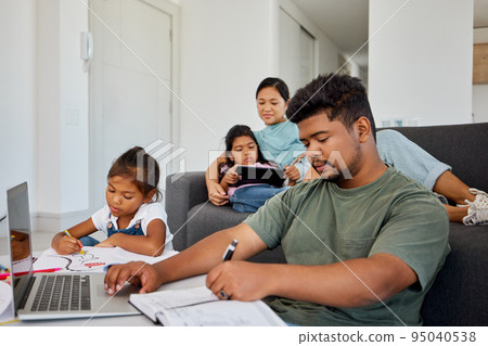 Family, children and education with a father working from home and his daughter doing homework for school. Learning, remote work and studying with a young girl and her dad busy in the living room Family, children and education with a father working from home and his daughter doing homework for school. Learning, remote work and studying with a young girl and her dad busy in the living room 95040538