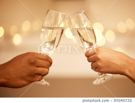 Champagne, toast and hands, a celebration with couple on romantic date drinking with bokeh. Love, romance and luxury, a man and woman cheers to hope of future relationship goal with glass and bubbles 95040720
