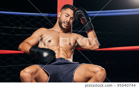 Sports, boxing ring and tired frustrated boxer with head pain, injury or fatigue from exhibition competition. Defeat or failure in fight challenge, workout or training burnout from fitness exercise Sports, boxing ring and tired frustrated boxer with head pain, injury or fatigue from exhibition competition. Defeat or failure in fight challenge, workout or training burnout from fitness exercise 95040744