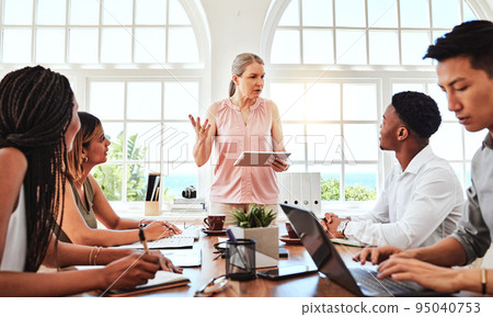Meeting, planning and training with a female leader, manager or boss in the boardroom for a workshop or seminar. Teamwork tablet and communication with a business woman and her team in discussion 95040753