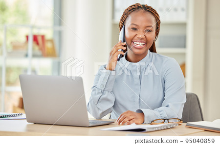 Black woman on laptop, business phone call and communication at office, work or workplace. Happy corporate female on smartphone, mobile or cellphone, conversation or talking while on computer. Black woman on laptop, business phone call and communication at office, work or workplace. Happy corporate female on smartphone, mobile or cellphone, conversation or talking while on computer. 95040859