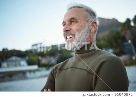 Surf, happy and senior man at the beach for peace, calm or freedom of the mind during holiday in Rio de Janeiro Brazil. Wetsuit, retirement sports and elderly person relax before surfing for wellness 95040875