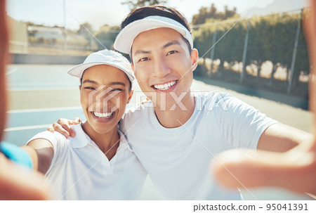 Selfie, tennis and court sports with people taking happy, smile and fun photograph for social media. Portrait of asian man, coach and winner woman after success training, workout and fitness exercise Selfie, tennis and court sports with people taking happy, smile and fun photograph for social media. Portrait of asian man, coach and winner woman after success training, workout and fitness exercise 95041391