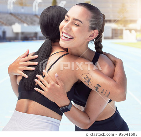 Friends hug and smile for congratulations, running or exercising outdoors on racetrack. Woman, support and winner, happy during summer workout for motivation and success, run for fitness and health 95041695