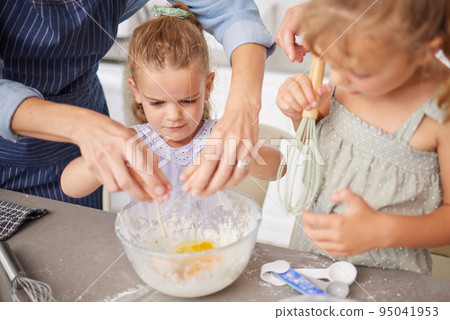 Cooking, girls or bonding mother helping with eggs for dessert, breakfast or sweet recipe in house or family home kitchen. Hands, parent and learning children in baking healthy food and wellness diet Cooking, girls or bonding mother helping with eggs for dessert, breakfast or sweet recipe in house or family home kitchen. Hands, parent and learning children in baking healthy food and wellness diet 95041953