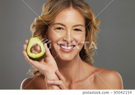 Skincare, avocado and smile on face of woman with fruit in hand for health, wellness and care. Model, skin and happy with avo in hand for healthy body, hair and beauty with facial product from nature Skincare, avocado and smile on face of woman with fruit in hand for health, wellness and care. Model, skin and happy with avo in hand for healthy body, hair and beauty with facial product from nature 95042154