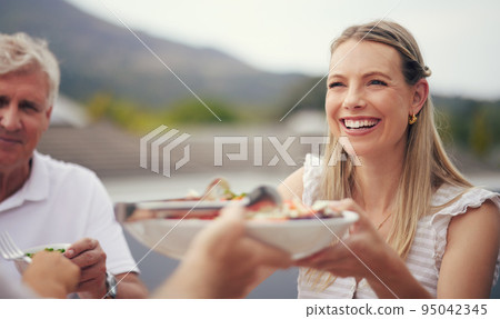 Family, serving food and bonding and eating on holiday, vacation or celebration event in agriculture nature or countryside. Smile, happy and relax woman with senior parent, dad or man for health meal Family, serving food and bonding and eating on holiday, vacation or celebration event in agriculture nature or countryside. Smile, happy and relax woman with senior parent, dad or man for health meal 95042345