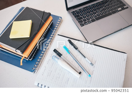 Paper, writing and idea with a notebook, laptop and books on a desk in an empty office for planning at work. Computer, email and strategy with still life objects on a table for business or creativity 95042351
