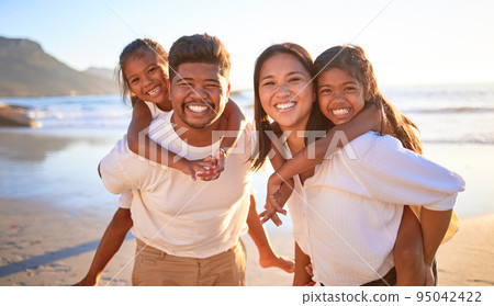 Family, beach vacation and smile of kids and parents having fun during piggyback ride game on summer travel holiday. Portrait of man, woman and girl children together for bonding trip in Indonesia 95042422