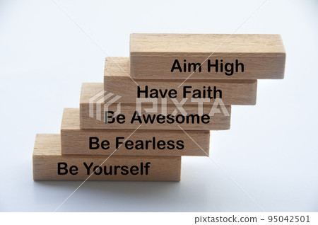Words of motivation on wooden blocks - Aim high, have faith, be awesome, be fearless, be yourself 95042501