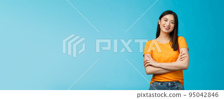 Cheerful friendly asian woman with dark short haircut smiling broadly enthusiastic conversation, talking you casually, cross arms chest confident pose, laughing carefree, stand blue background Cheerful friendly asian woman with dark short haircut smiling broadly enthusiastic conversation, talking you casually, cross arms chest confident pose, laughing carefree, stand blue background 95042846