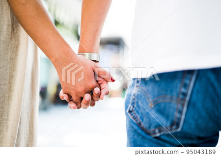 Man and woman holding hands couple love Man and woman holding hands couple love 95043189