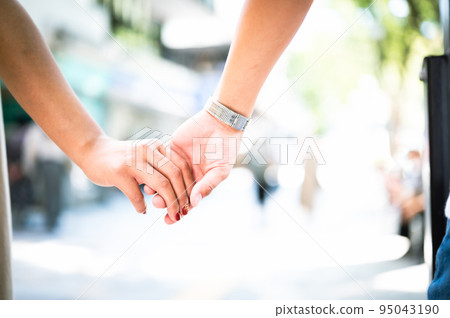 Man and woman holding hands couple love 95043190