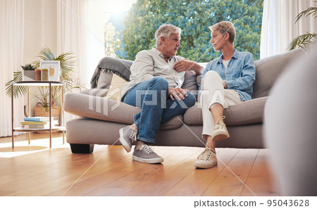 Senior couple, serious talk and communication about problems and marriage issues while sitting on the sofa at home. Mature man and woman talking and discussing issues, trouble and divorce Senior couple, serious talk and communication about problems and marriage issues while sitting on the sofa at home. Mature man and woman talking and discussing issues, trouble and divorce 95043628